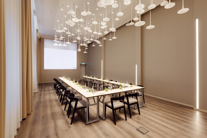 An event room with ceiling-high windows and space for 50 guests.