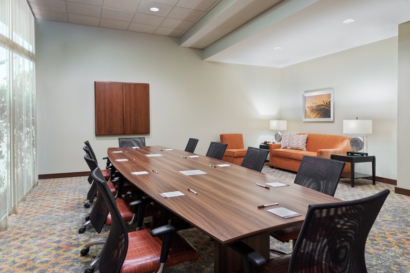 Alfa meeting room features a Boardroom table, sofa and bathroom.