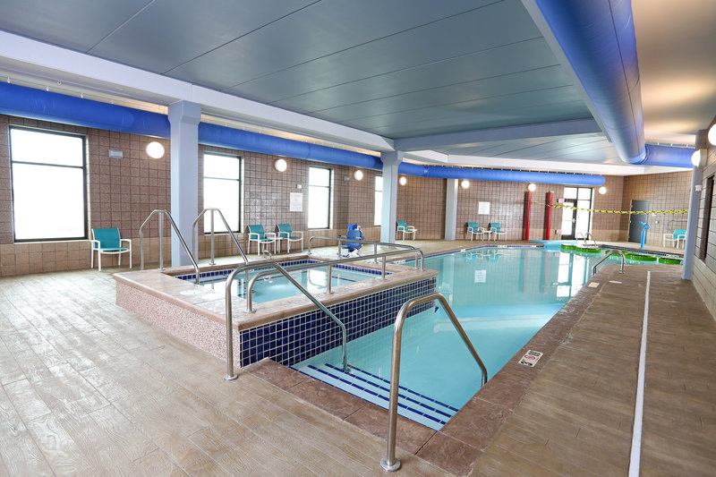 Swimming pool with elevated hot tub