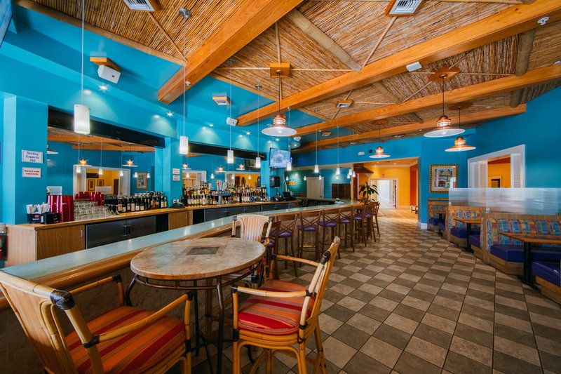 Indoor seating and bar at Cape Grill & Bar.