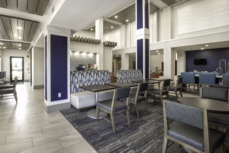 Enjoy a hot breakfast in comfy seating with 2 flat screen TVs